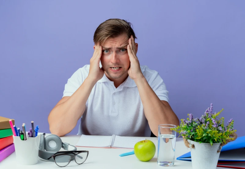 Adult with ADHD struggling to focus at desk