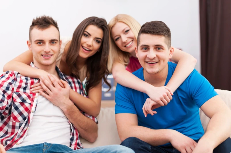 Diverse adults smiling together in a therapy office
