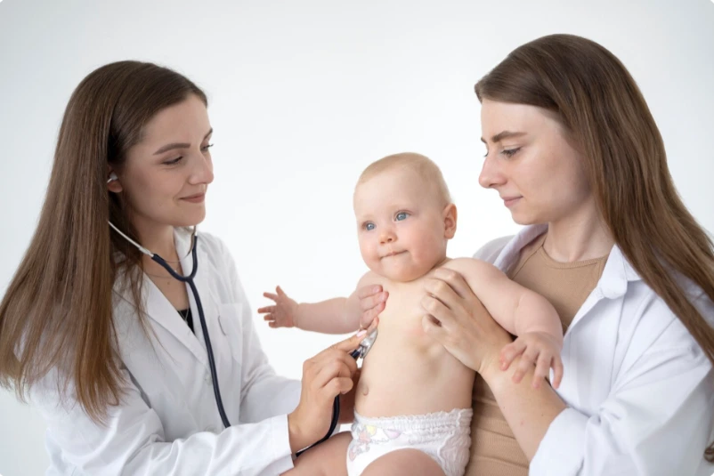 Female doctor talking with a new mother and baby during a supportive postpartum depression consultation