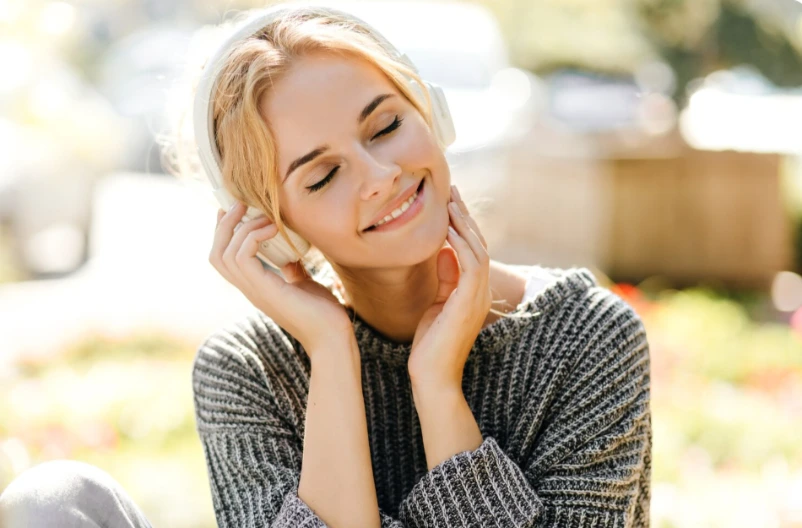 Happy adult woman smiling outdoors in morning light, stable and thriving with ongoing psychiatric follow-up care