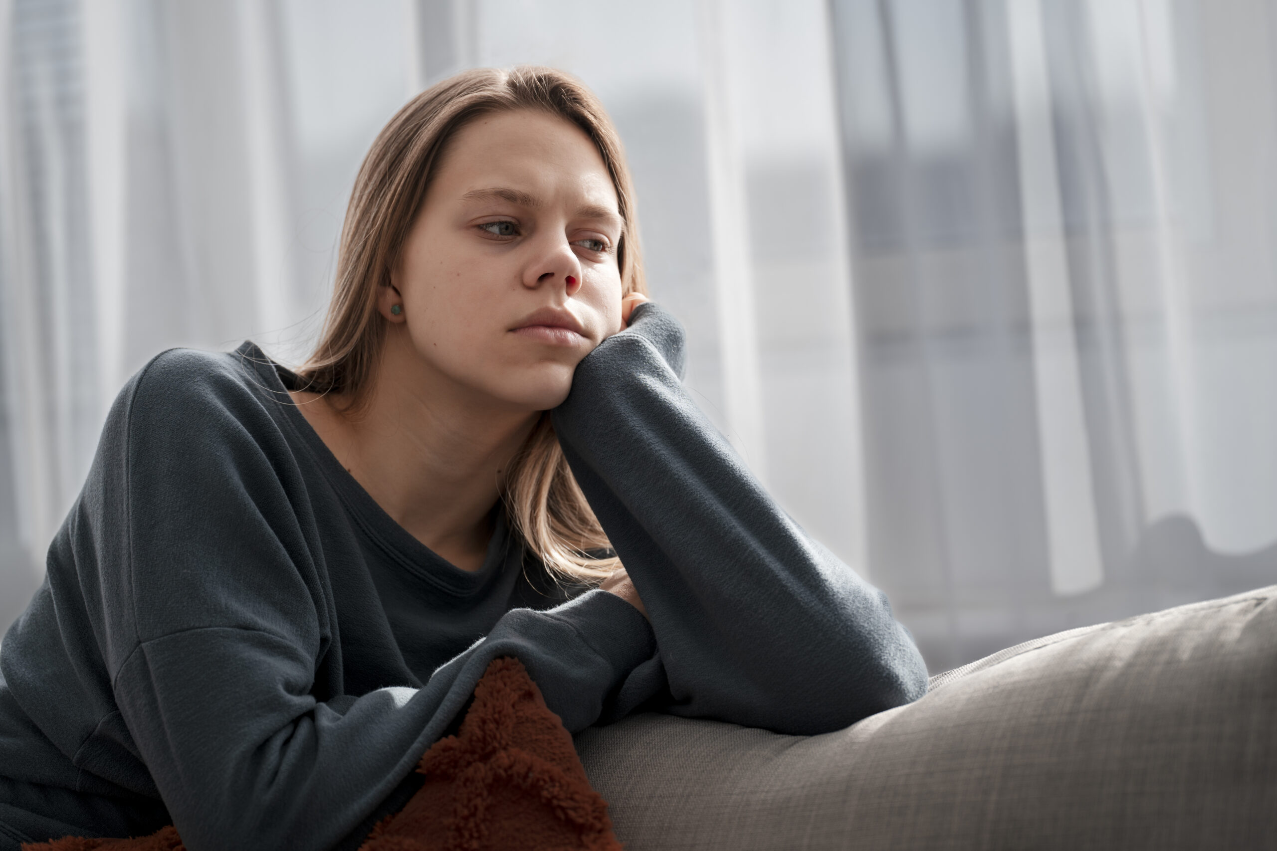 Woman struggling with depression and anxiety at home