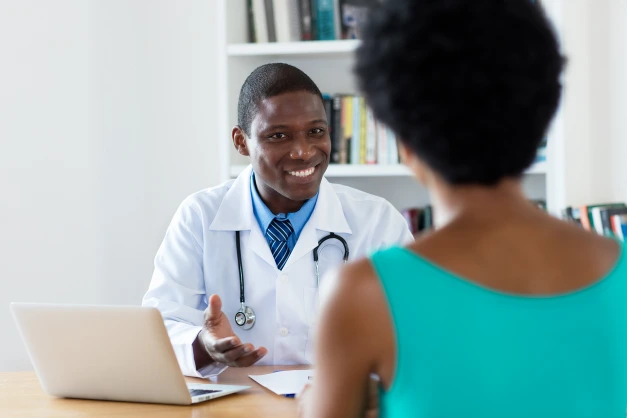 Smiling Black psychiatrist consulting with a patient at Harmony Health and Psychiatry