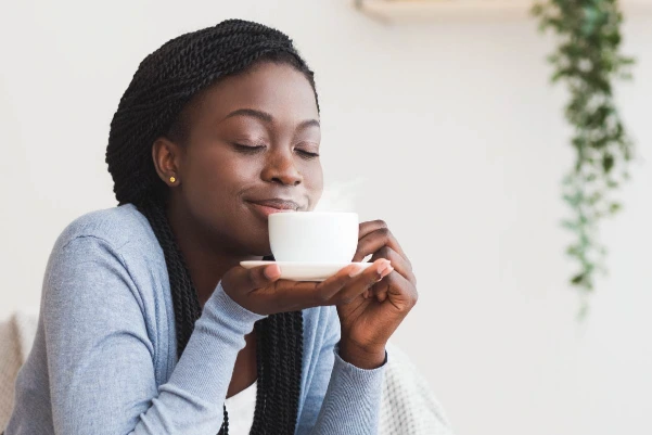 Black woman relaxing at home, representing convenient telehealth psychiatric care